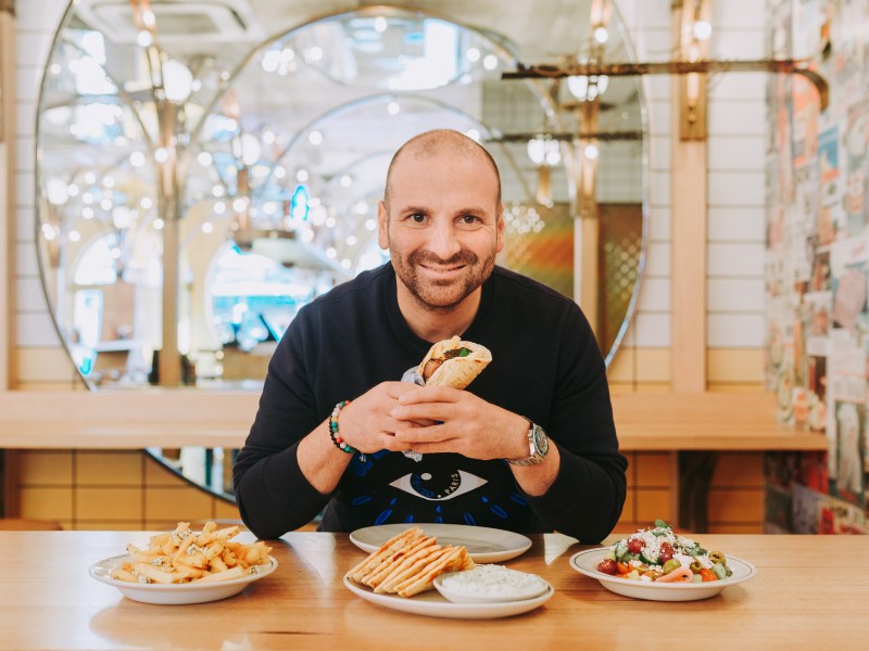 George Calombaris holding a slouvaki in Made Establishment owned jimmy Grants