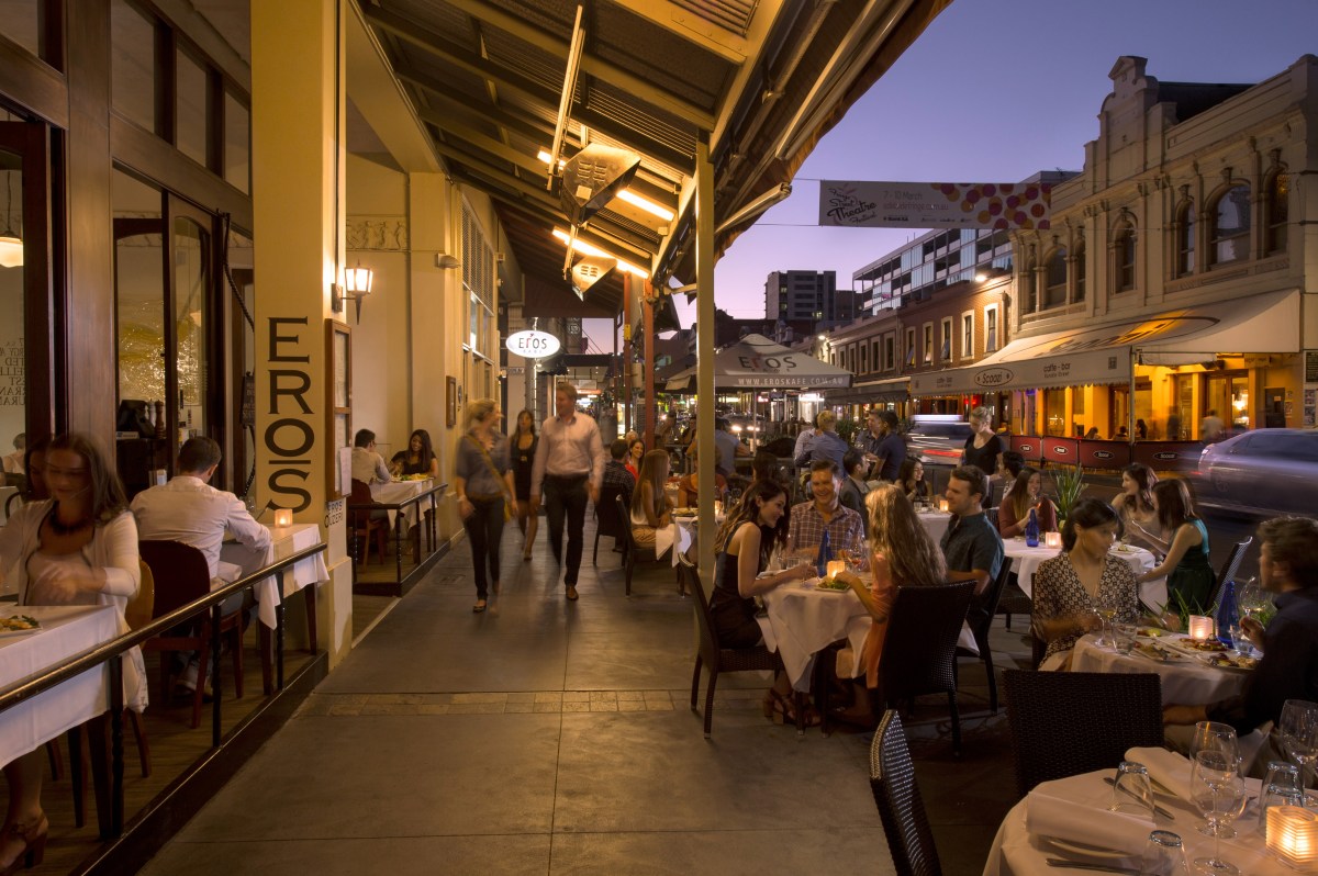 People dining at outdoor tables in Adelaide.
