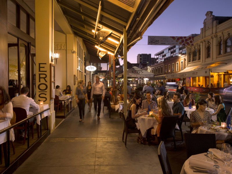 People dining at outdoor tables in Adelaide.