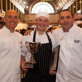 L-R: 2016 competitor Stephen Blant presents his dishes to the judging panel – Head Judge John McFadden, Sam Burke and Karen Doyle.